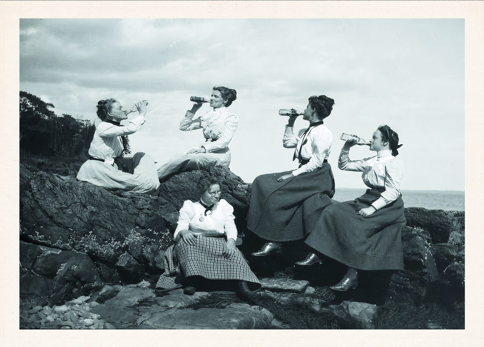 Historic black-and-white photo of women picnicking on the Maine coast